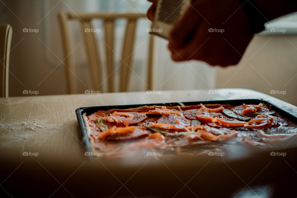 Cooking pizza with cheese at home