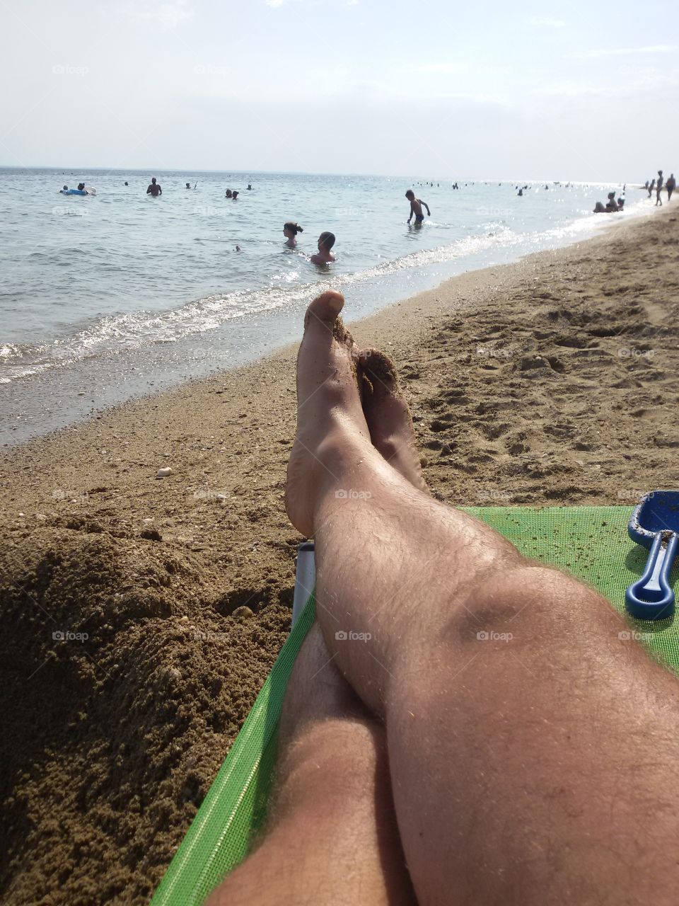 Man's leg on a sunbed on beach