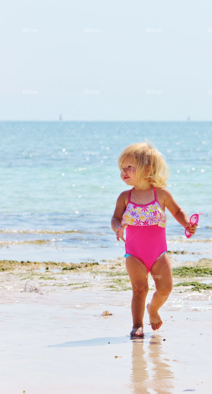 Blonde beautiful young girl at beach