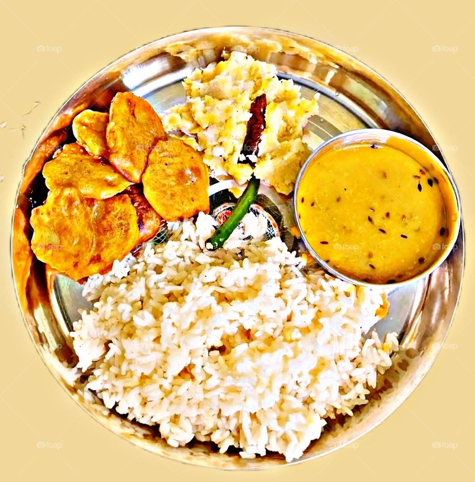 The most popular and favorite food. Dal and rice are being enjoyed.