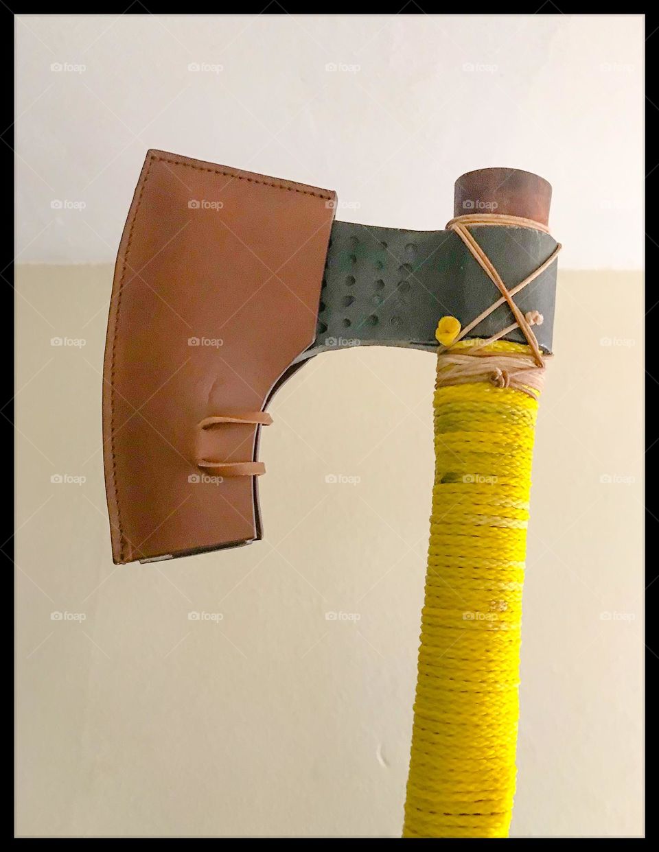 A personalized battle-ready Norse bearded ax with protective leather sheath.