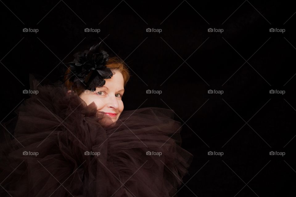 Beautiful happy woman on black background