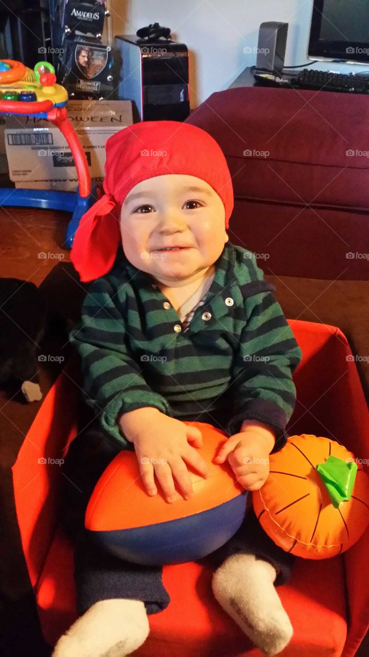 Baby smilling with a pirate hat for Halloween!