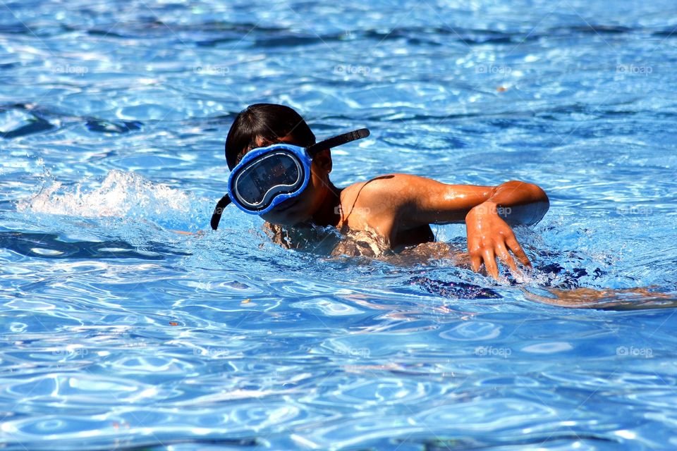 teen swimming in a pool