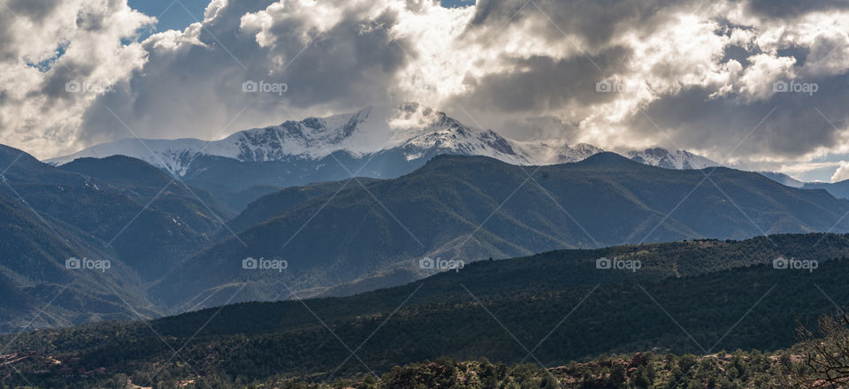 Scenic view of valley against cloudy sky