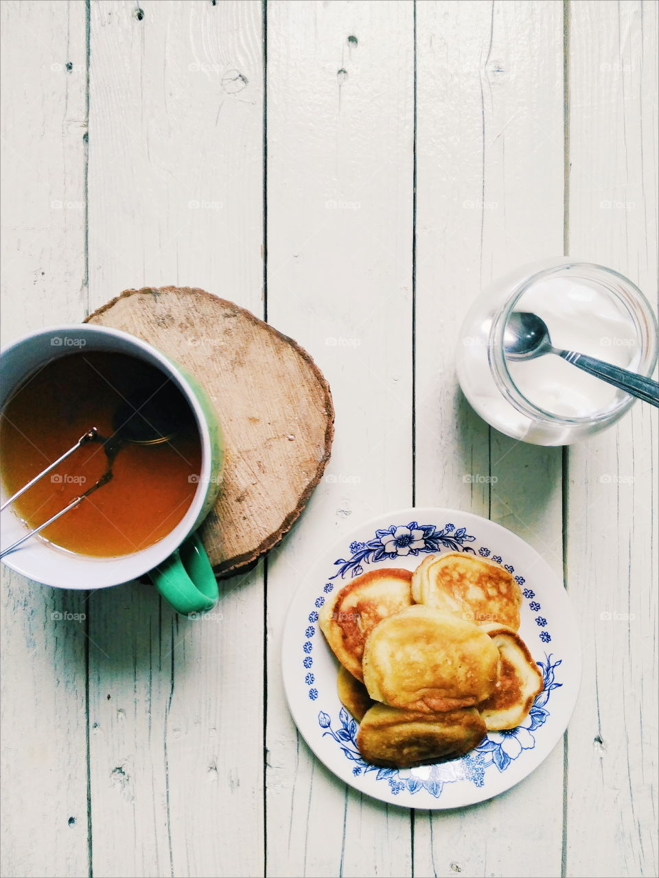 homemade pancakes, a cup of tea and sour cream for breakfast