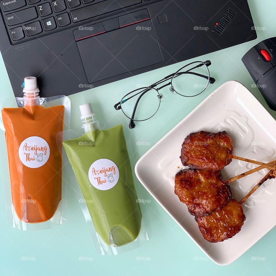 Grilled pork skewers moo ping and Thai milk tea 