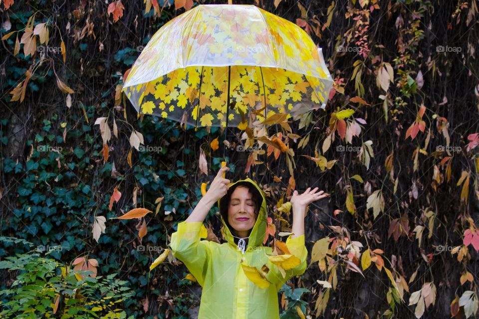 Woman with Umbrella on Autumn Background