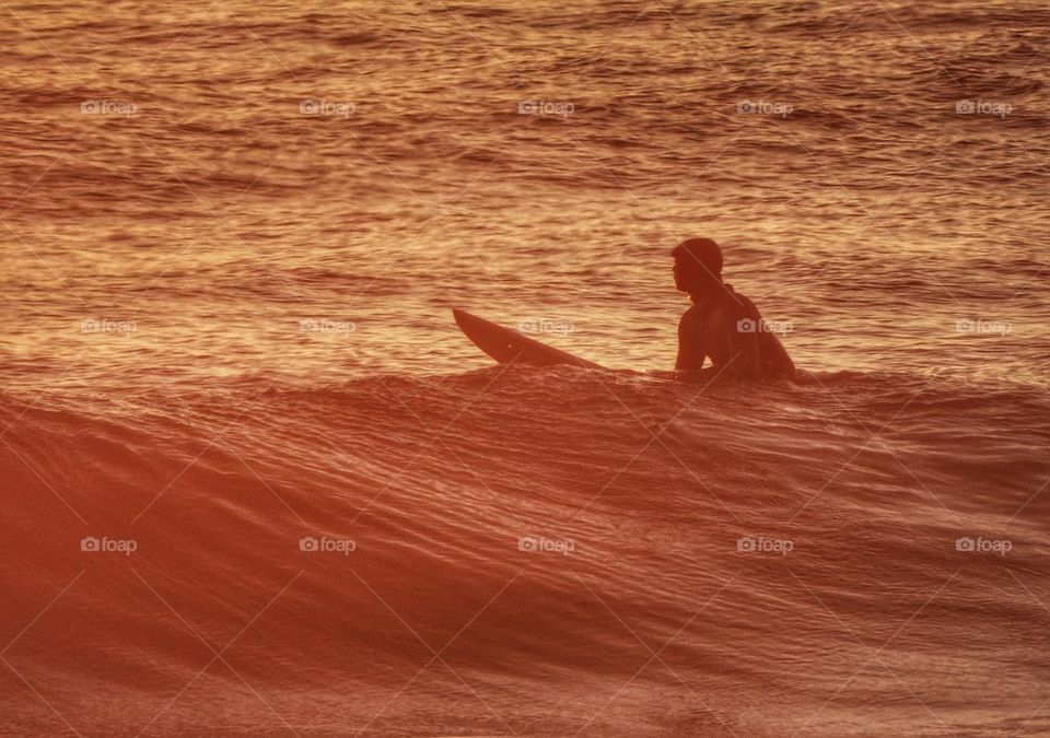 Surfing At Sunset. California Surfing During The Golden Hour