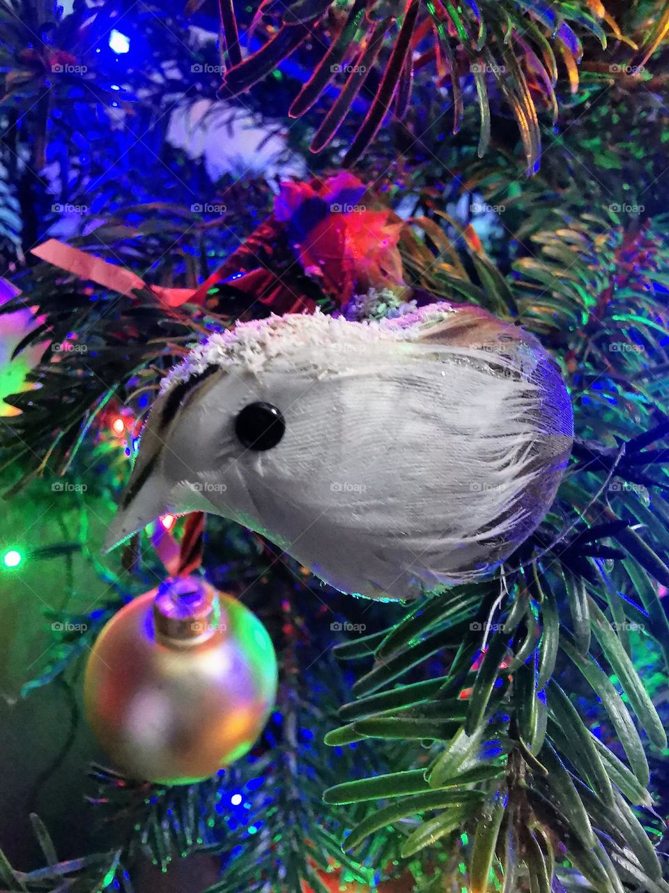 Bird Christmas tree decoration with other decorations in the background