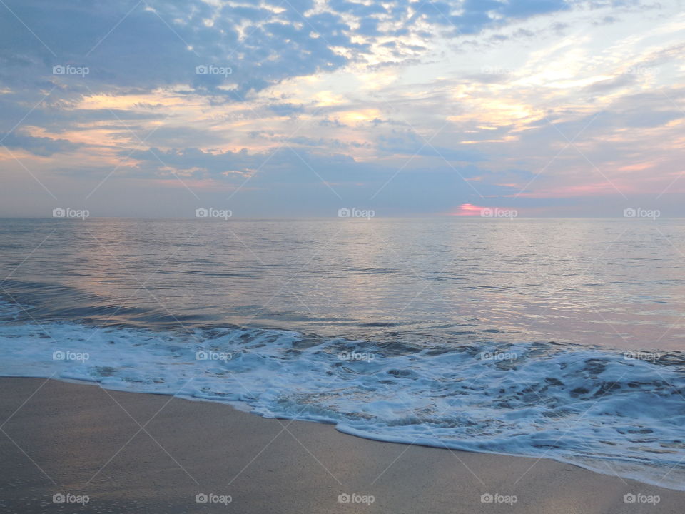 Dewey beach Delaware wave crashed out morning sunrise on cloudy day