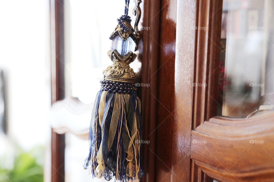 Golden and blue tassel on a wooden furniture 