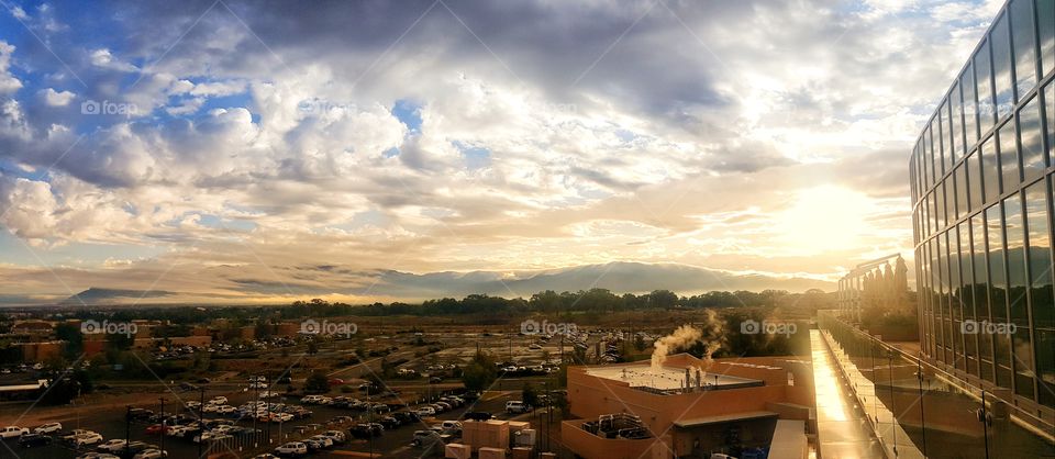 Sky glow over the city with mountains in the distance