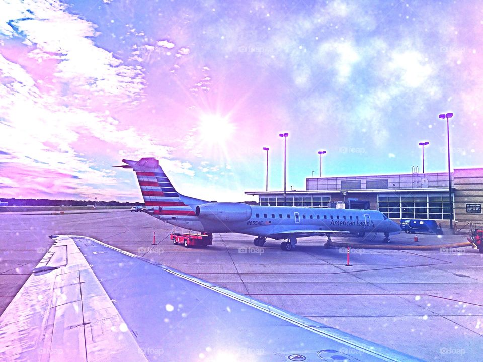Sunset on the Tarmac . Sunset reflected on to the wing of a jet plane.