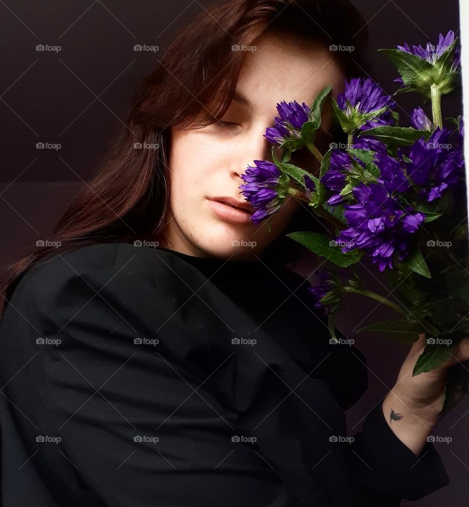 Portrait of a girl with purple flowers
