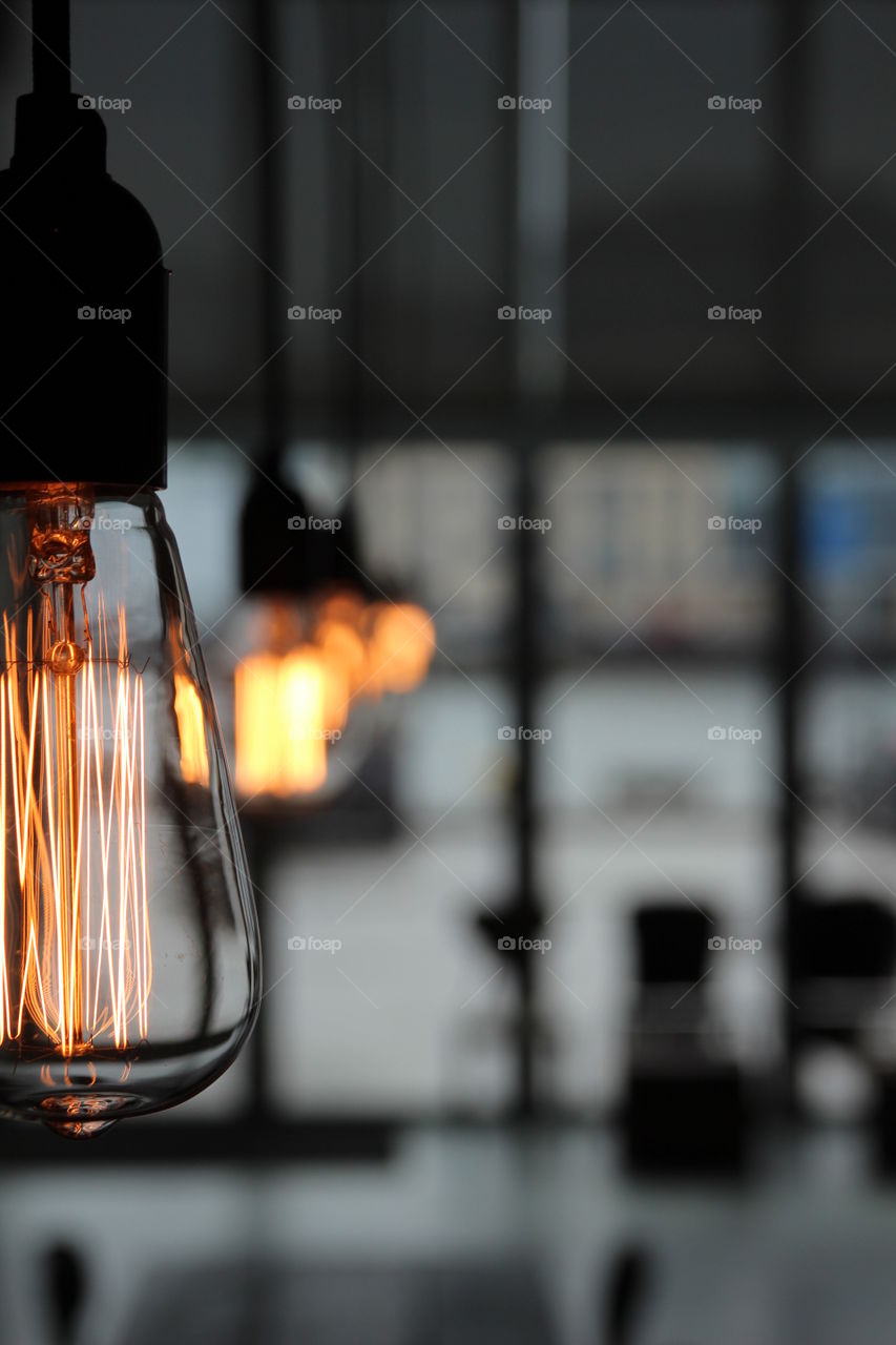 Illuminated light bulbs in restaurant