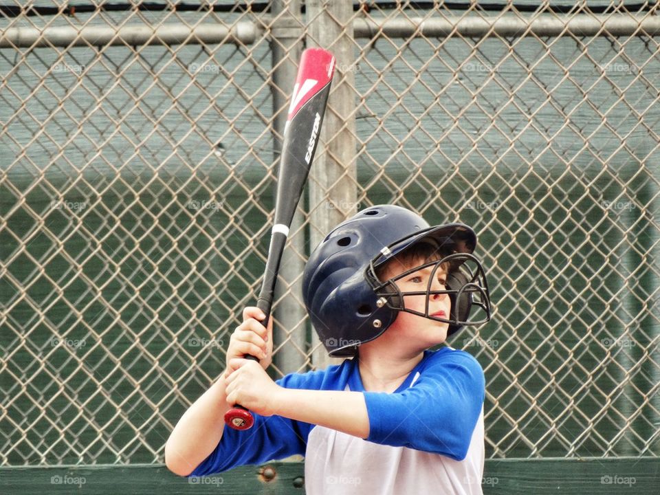 Little League Player Ready To Swing
