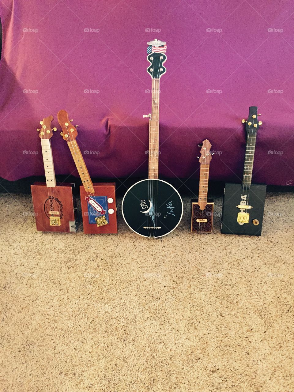 All handmade wooden stringed cigar box guitars and banjo. 