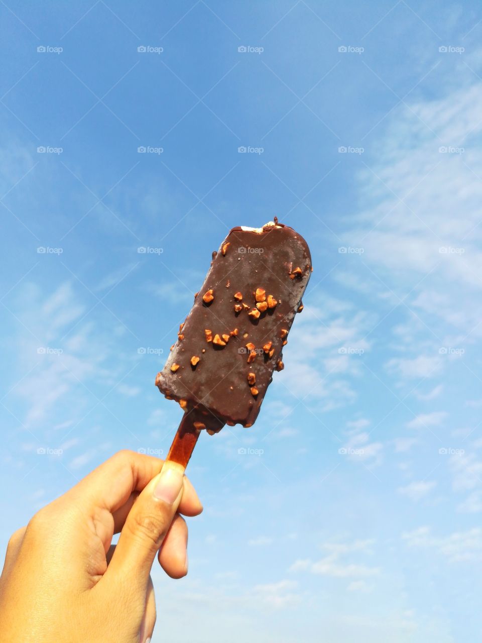 Chocolate ice against beautiful sky in summer season.