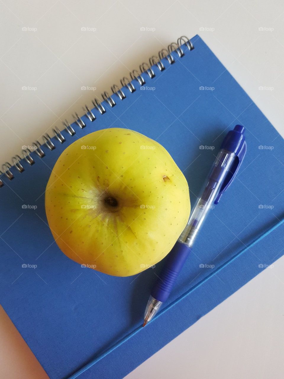 green apple on a notebook