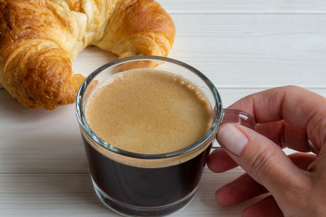 hand holding glass of coffee