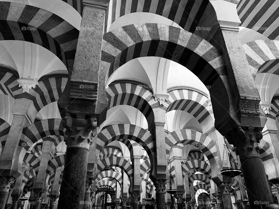 Arches and columns architecture inside the Mezquita, the mosque cathedral of Cordoba, Spain