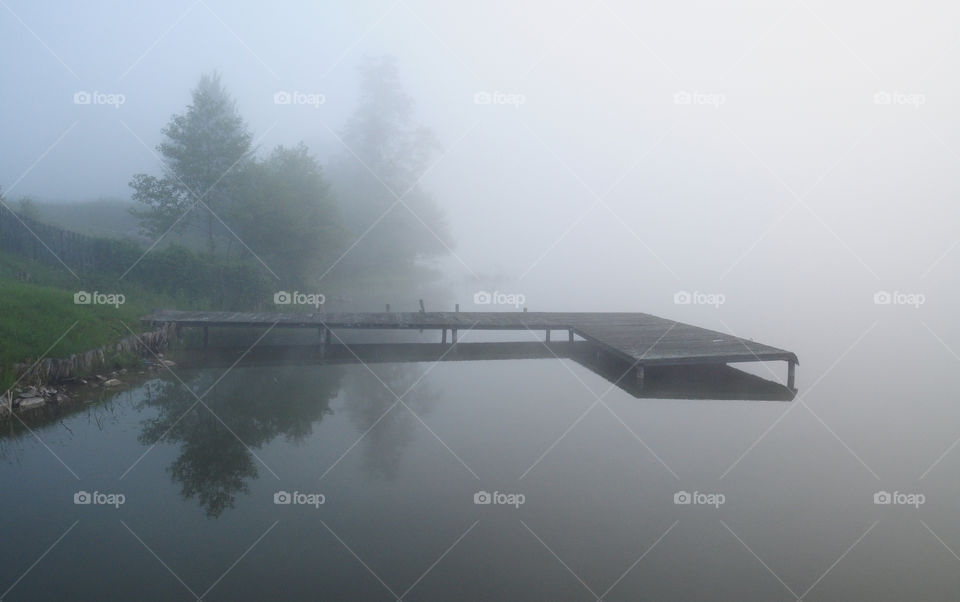 grey foggy morning at the lake in Poland