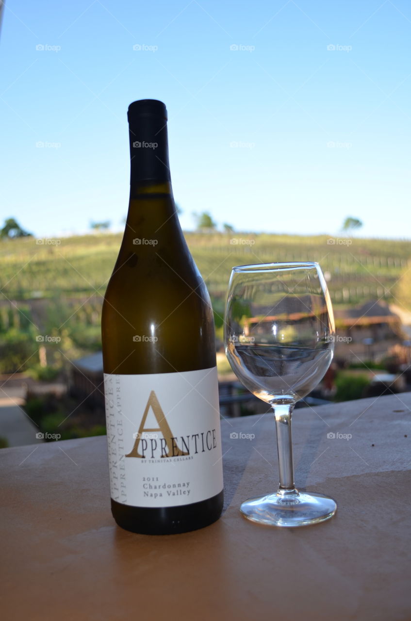 Wine Time. Napa Valley Wine and winery in the background. 