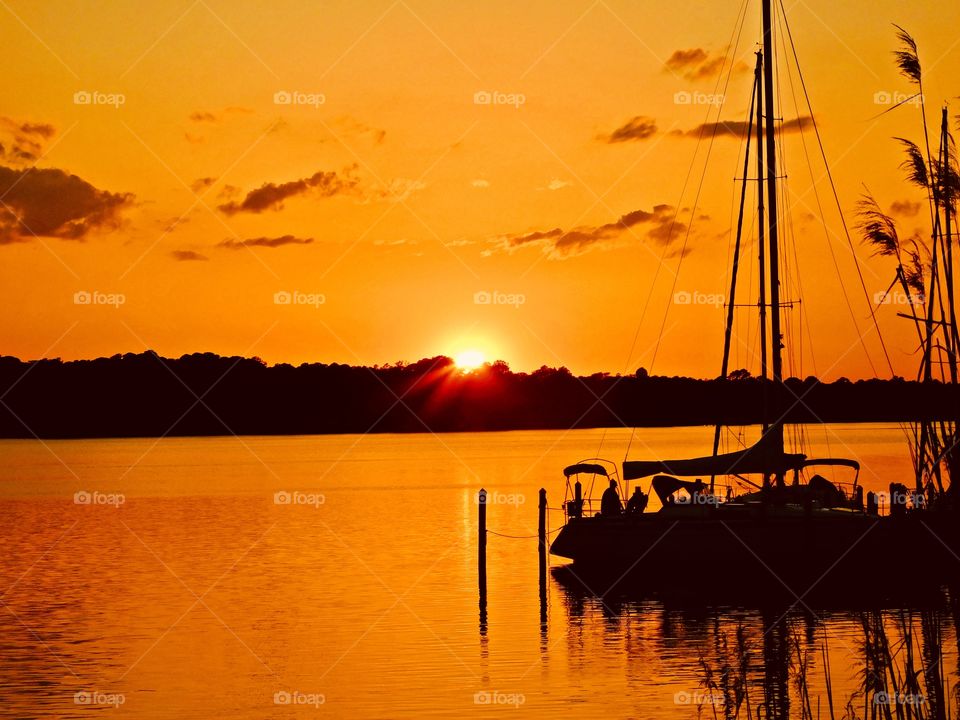 Sunrise, sunset and the moon - The sailboat and its crew prepare to sail in the spectacular golden sunset