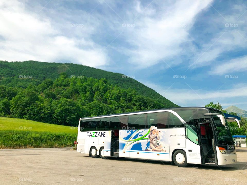 Summer travel by bus near mountains 