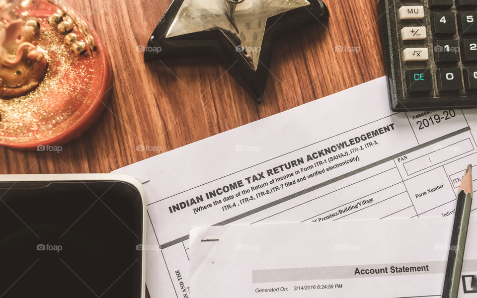 Close up of Indian Income tax return form ITR-2 return form is on the table next to a pen, calculator and a home mortgage loan application form placed on the desk. Financial Business concept.