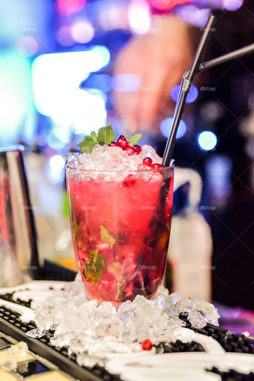 Glass of pomegranate juice with crushed ice