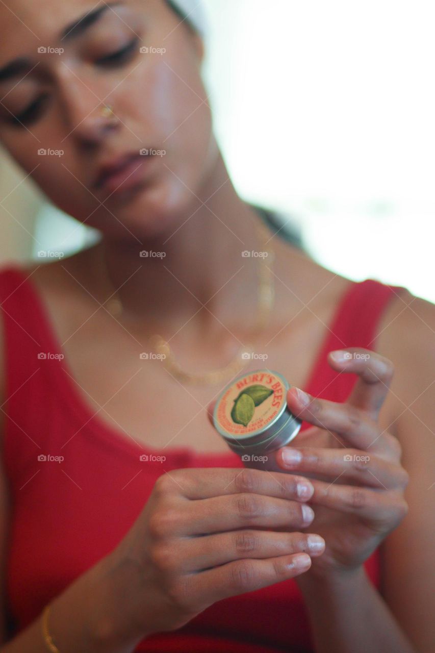 Young woman is holding Burt's bees product