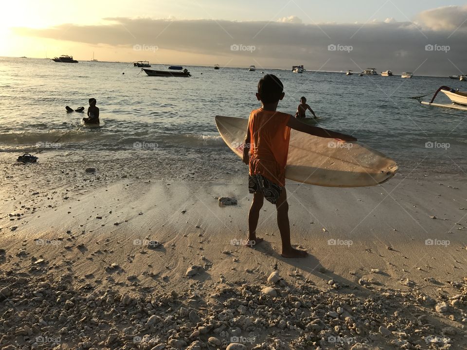 Kid surfing in Indonesia 