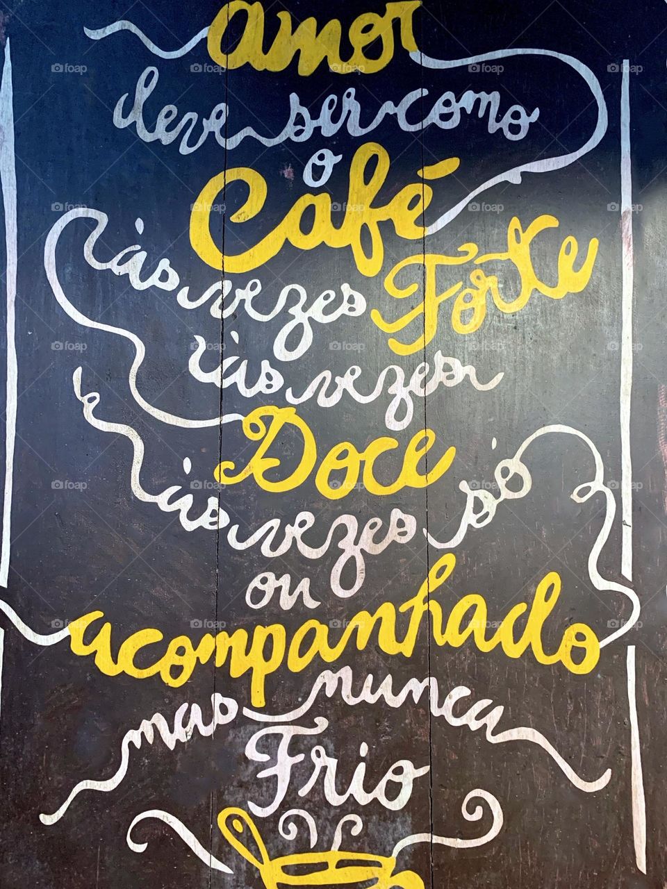 Wall of a coffee shop decorated with phrases about coffee