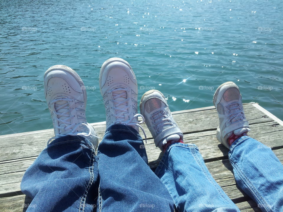 blue water. my daughter and I sitting on a dock at the lake of the Ozarks in Ha Ha Tonka State Park
