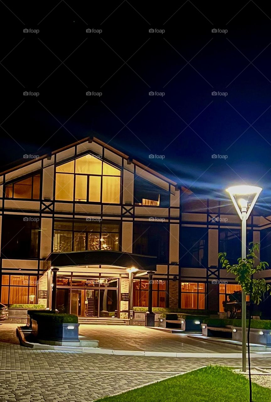 Country house in the evening with illuminated windows