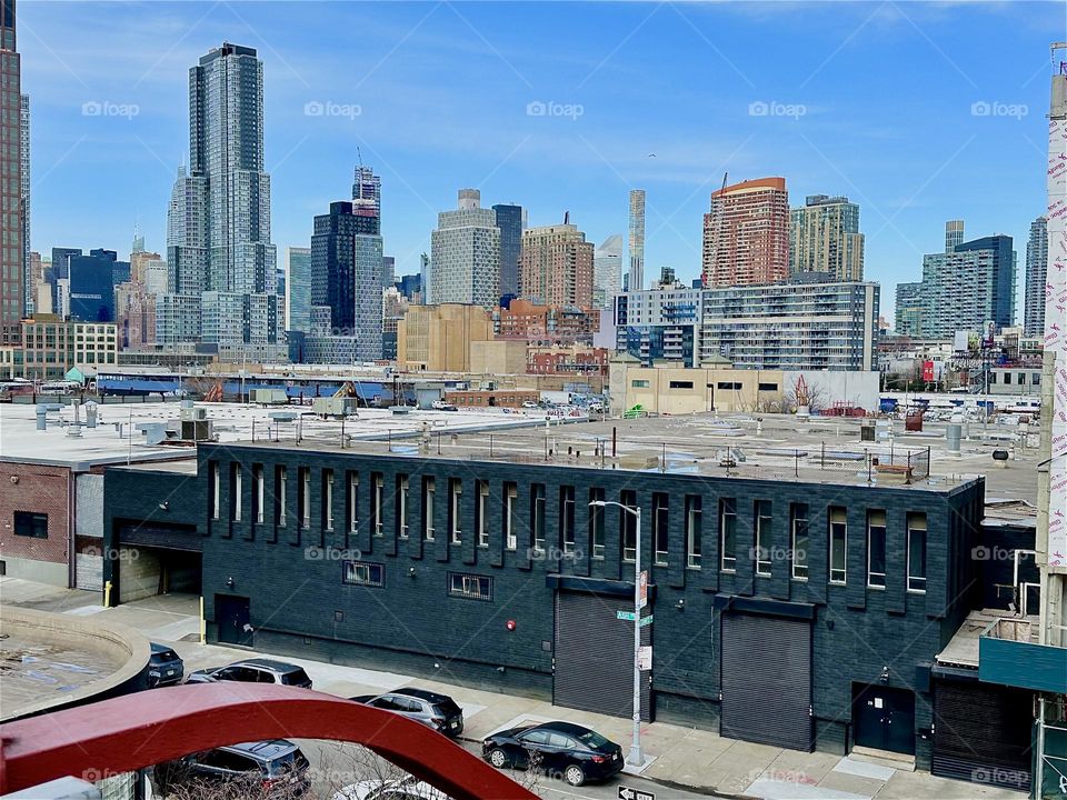 This is the view from the top of the red metal staircase of the „Pulaski Bridge“ at „Newtown Creek“ on the „Greenpoint“, Brooklyn side of the bridge. 2024. Hypnotic Productions