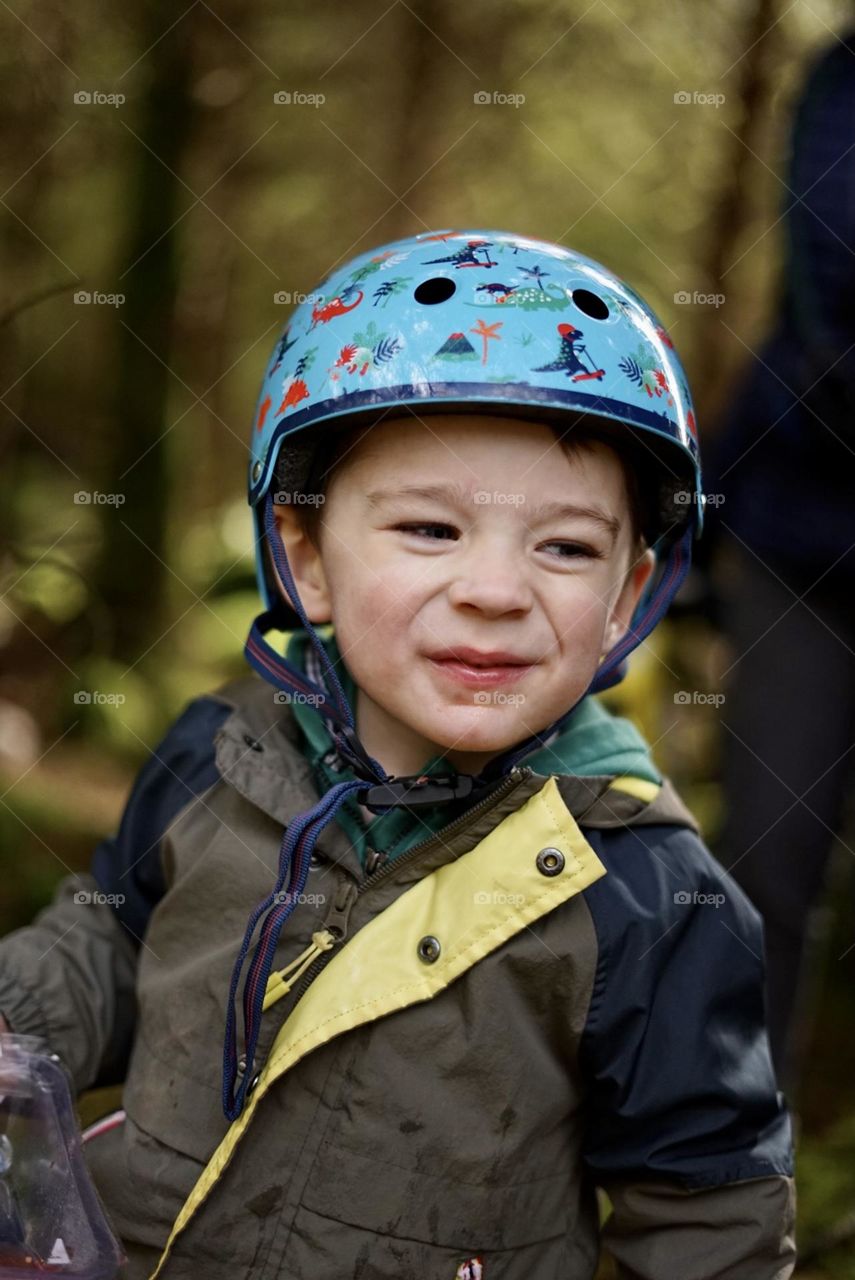 Happy boy outdoors in crash helmet