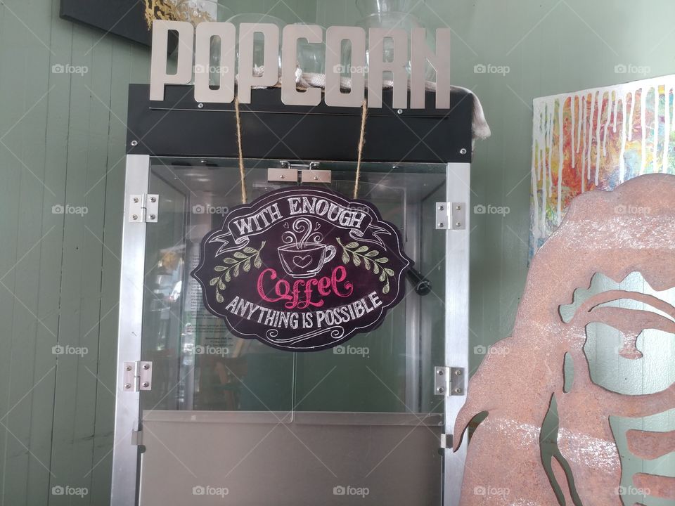 popcorn machine with a coffee sign on it.