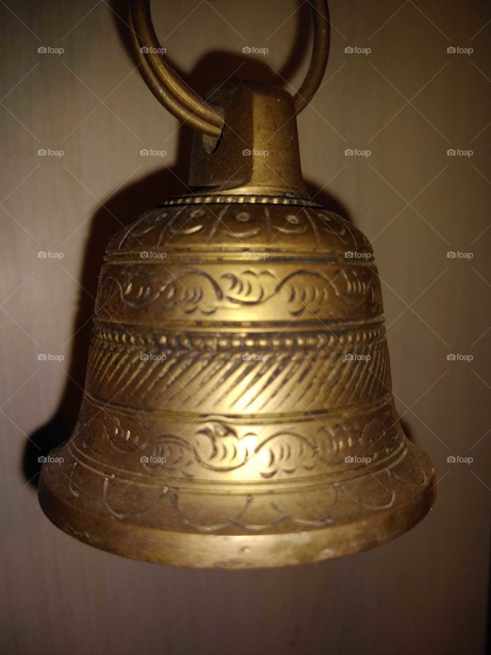 a brass bell on the wall