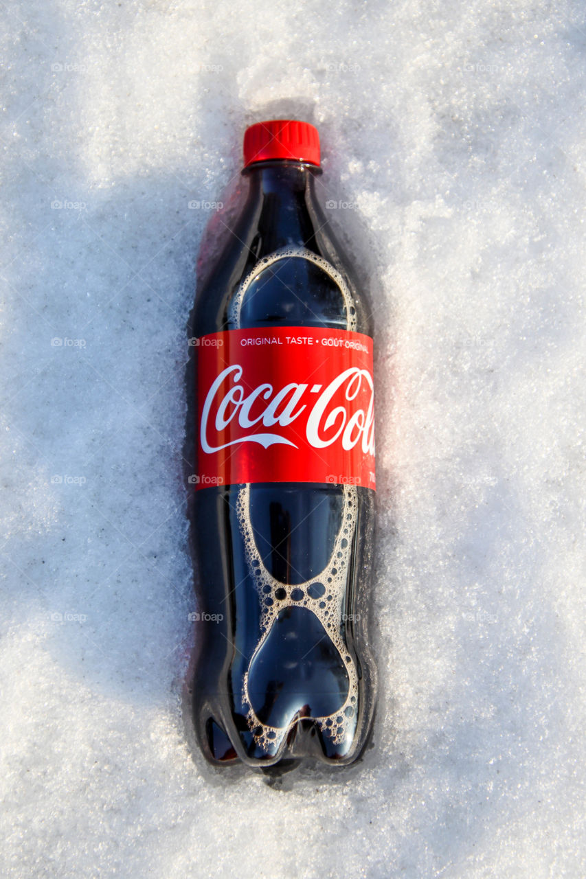 Bottle of a Coca-Cola in the snow