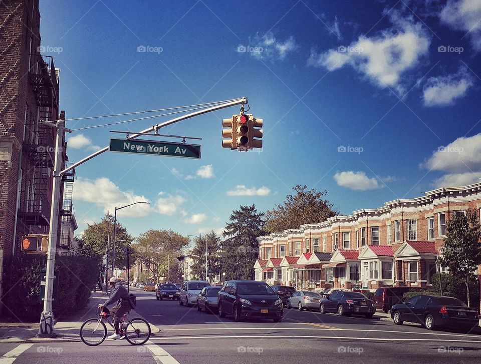 Cyclist pedal in Brooklyn street in a sunny blue sky day