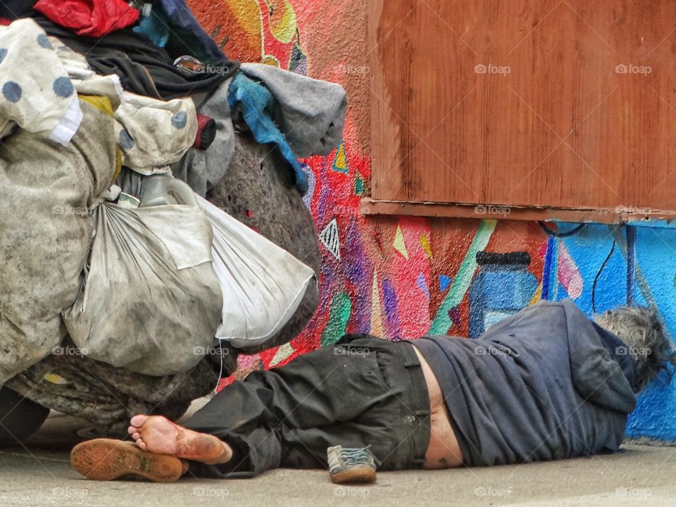 Homeless Person On The Street. Homeless Man Sleeping On The Sidewalk In San Francisco's Soma District

