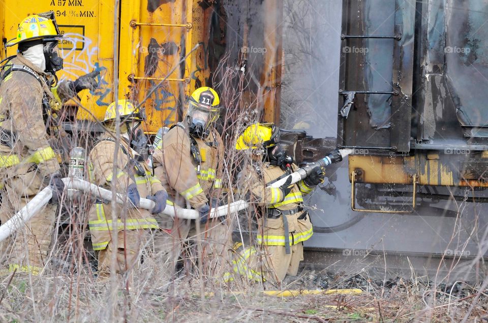 Firefighters work on train fire. 