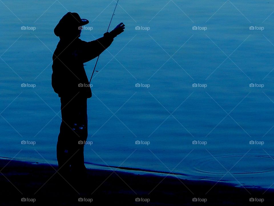 Silhouette of fisherman 