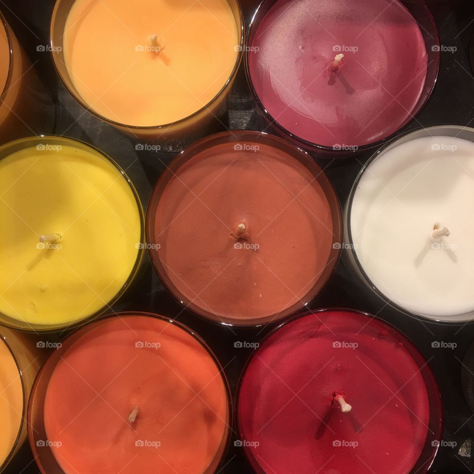 Overhead view of colorful votive candles. 