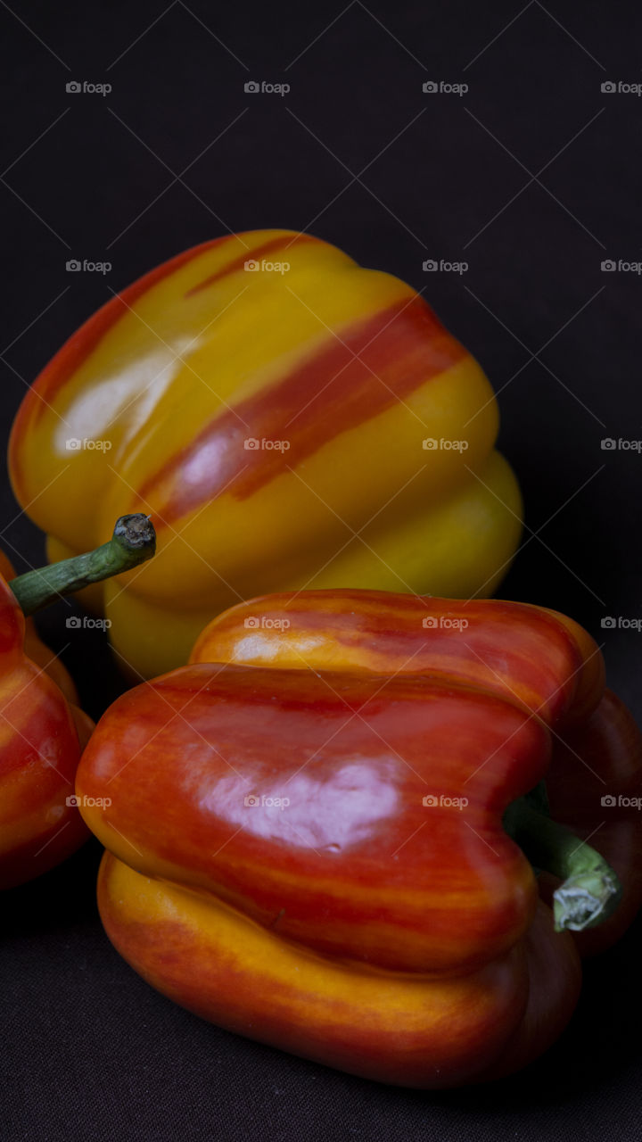 yellow-red peppers on a dark background