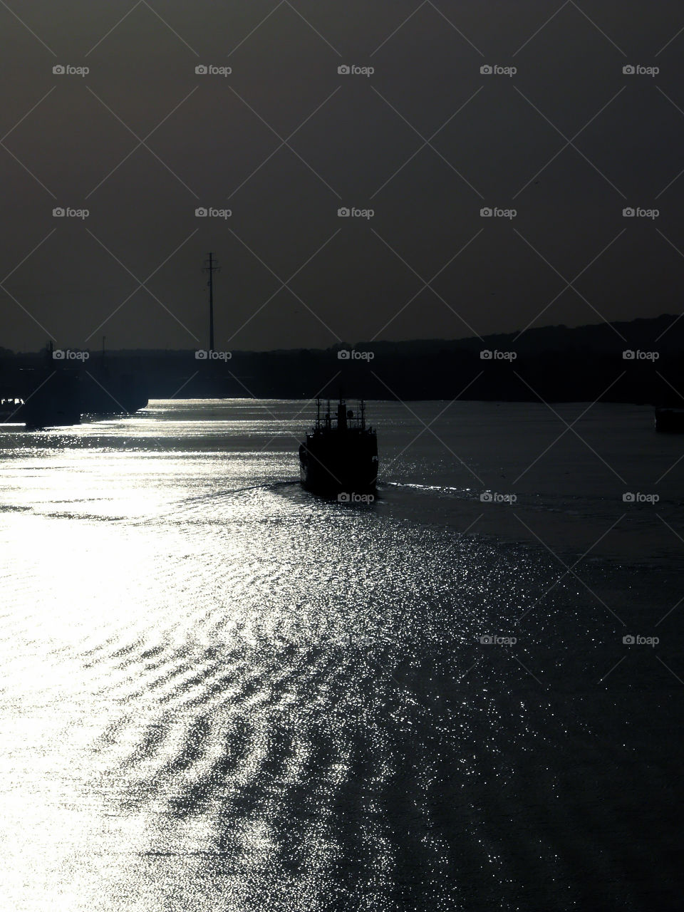 Silhouette of boat on water in Świnoujście, Poland.