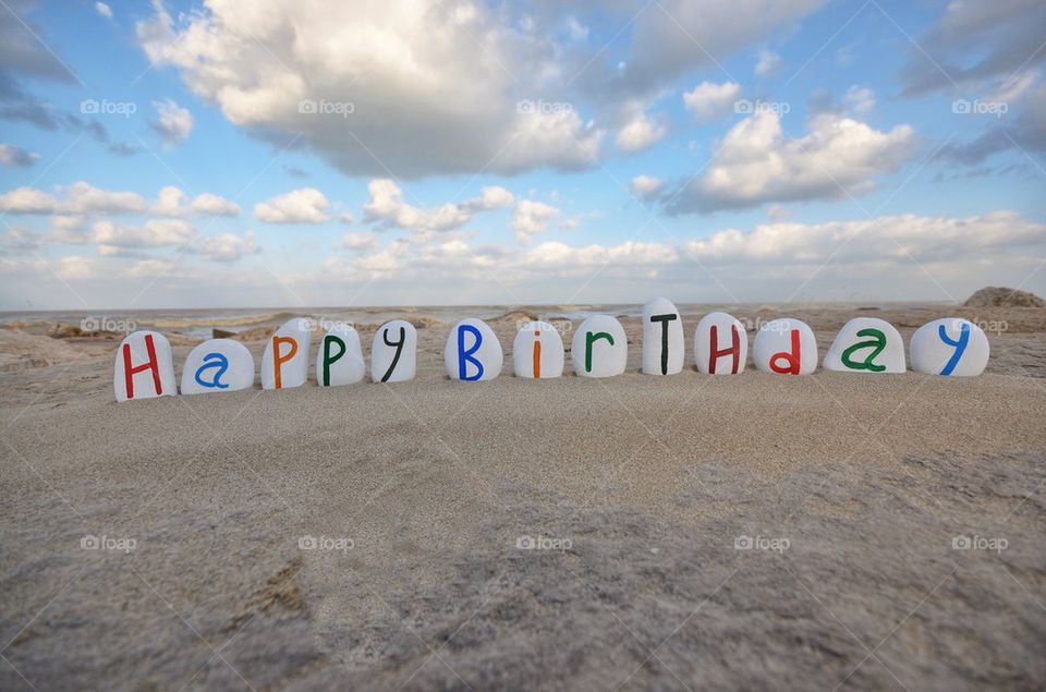 Happy Birthday message on coloured stone